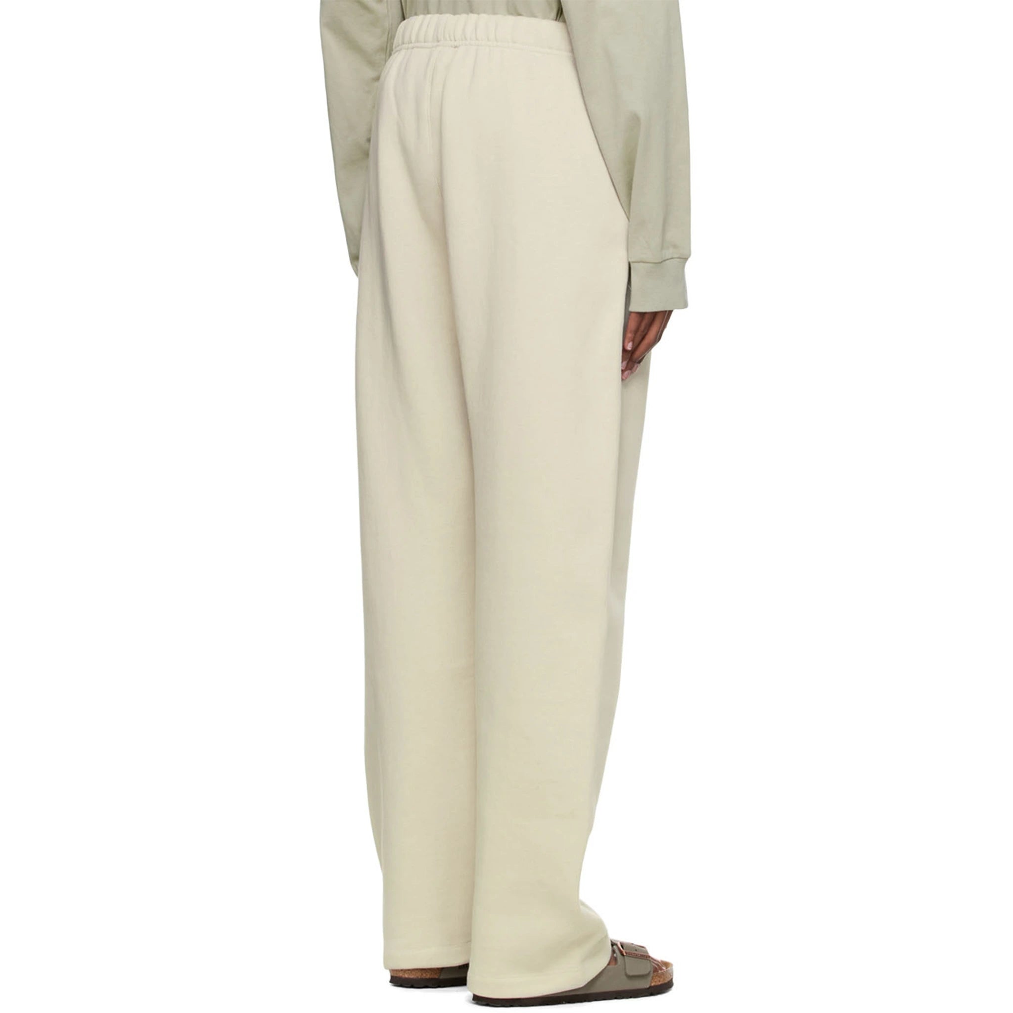 Model back view of Fear Of God Essentials Relaxed Wheat Sweatpants (SS22) 130BT212047F